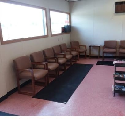 The waiting area at Toby's: a row of wooden chairs along a bright window